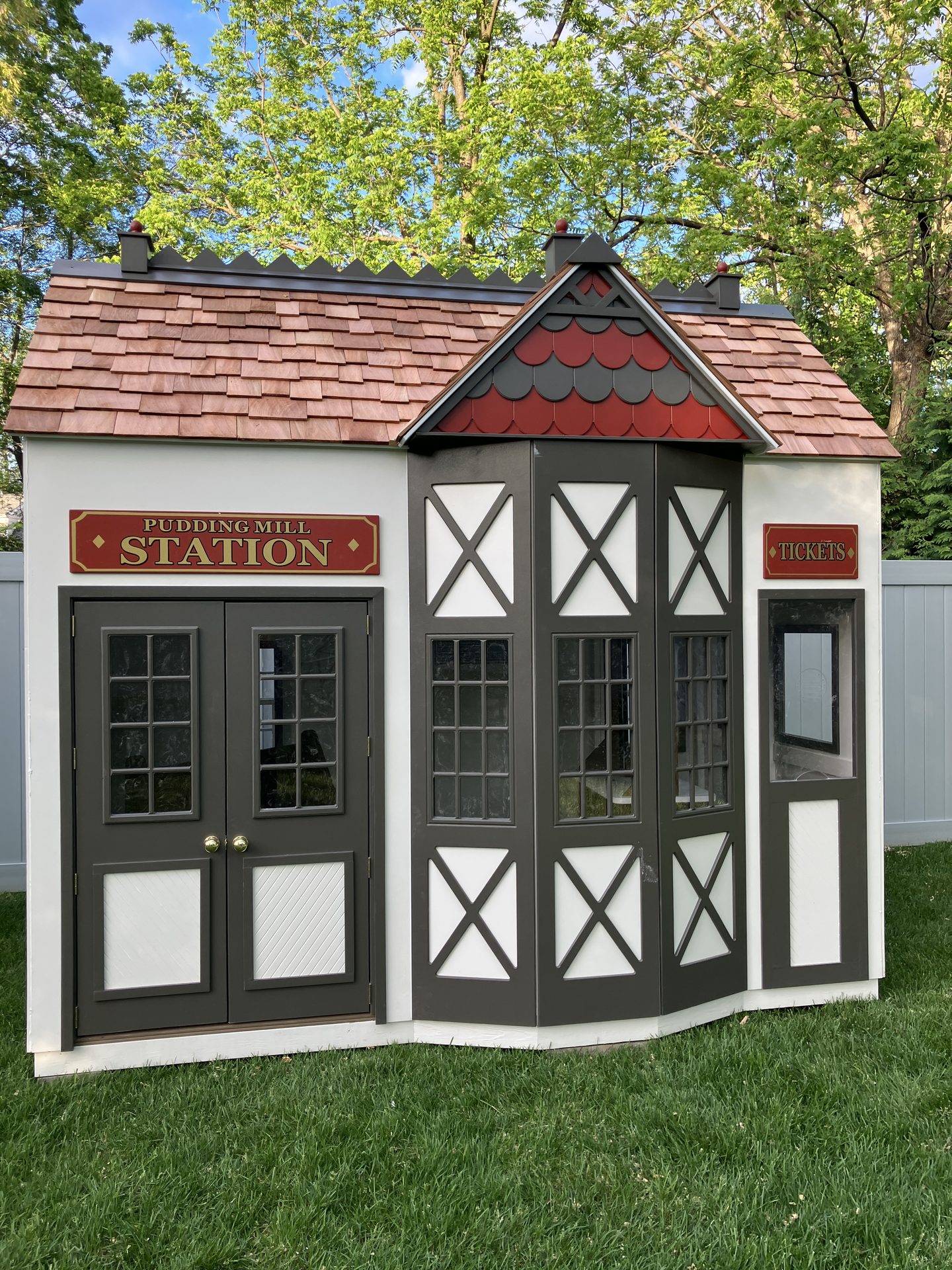 The 'Pudding Hill Station' detailed playhouse — part of Creative Cube's outdoor mini-village.