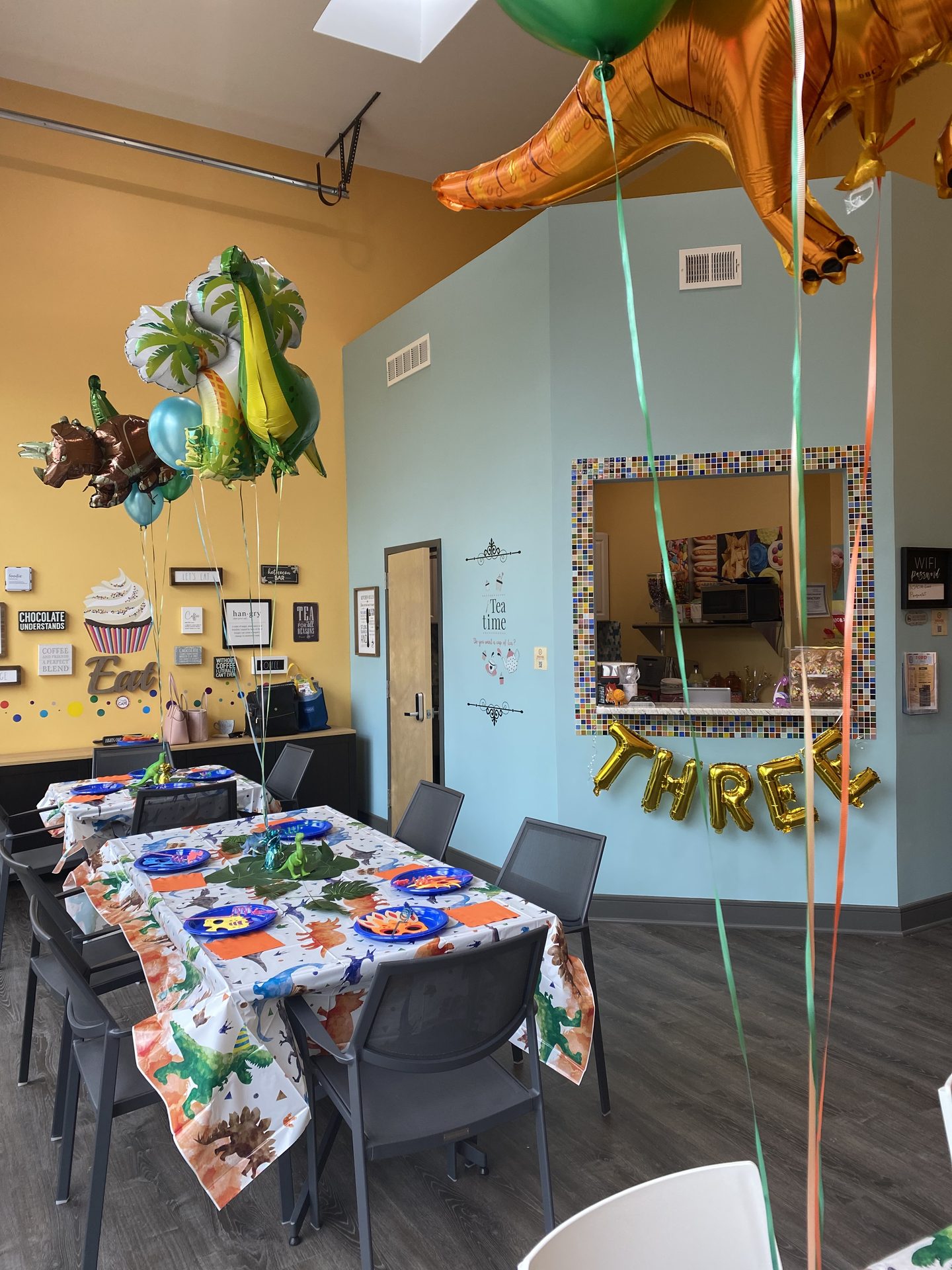 Inside the party room — set up for a dinosaur-themed birthday.