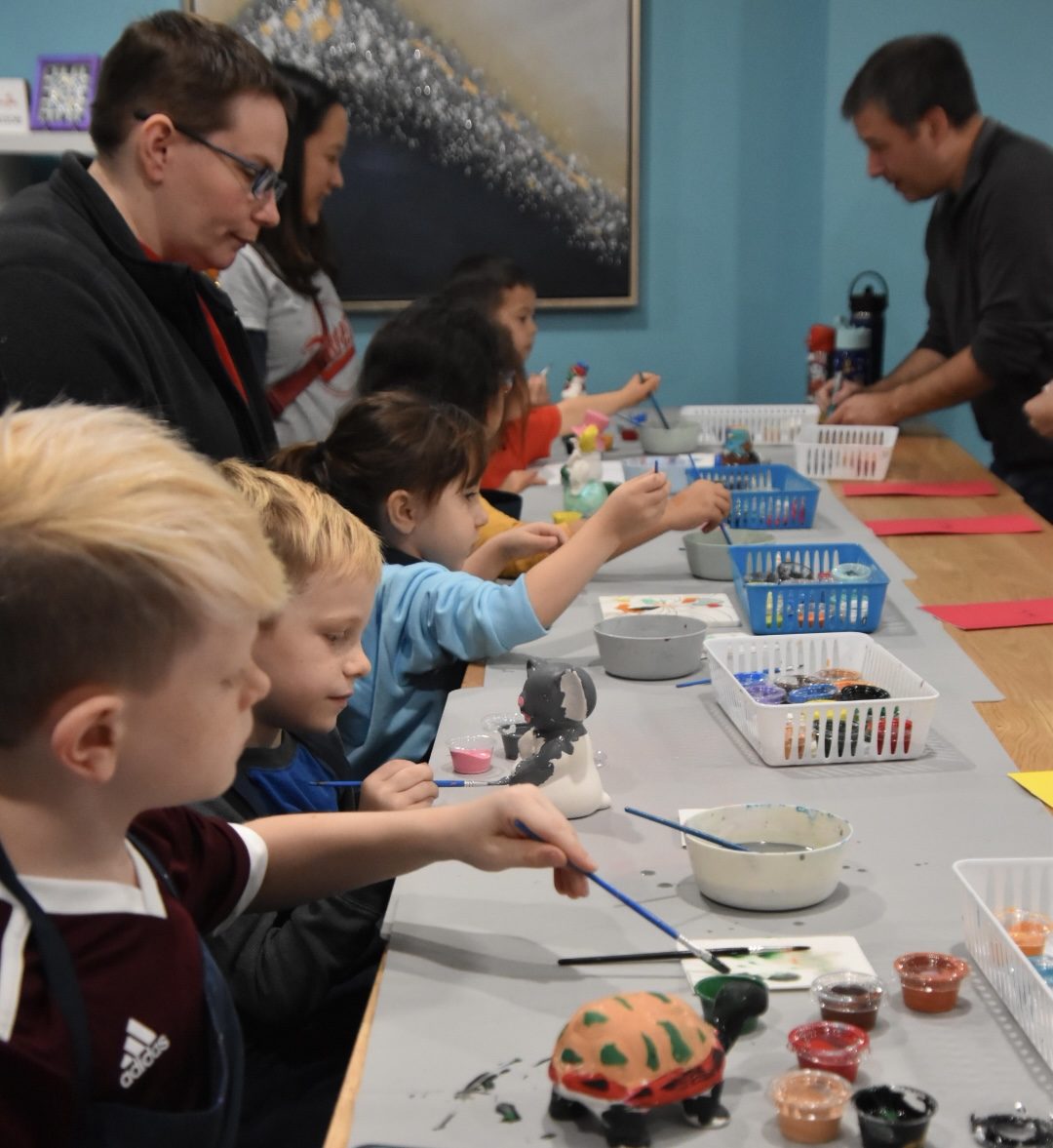 A group party in the studio, kids painting together.